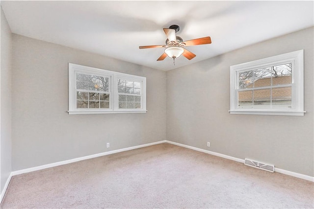 empty room featuring carpet and ceiling fan