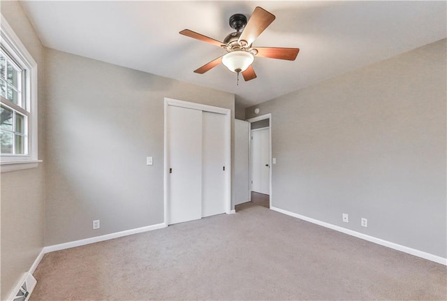 unfurnished bedroom with ceiling fan, carpet floors, and a closet