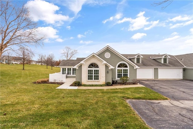 ranch-style home with a garage and a front yard