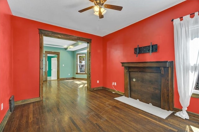 unfurnished living room with ceiling fan and dark wood-type flooring