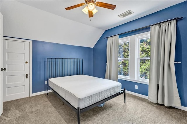 carpeted bedroom with ceiling fan and lofted ceiling