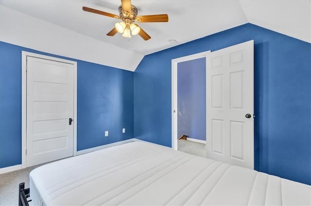 bedroom with ceiling fan, carpet floors, and vaulted ceiling