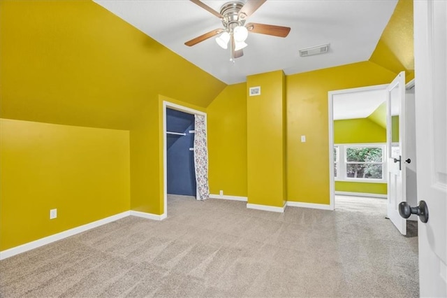 additional living space featuring ceiling fan, light carpet, and lofted ceiling