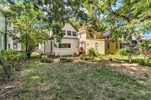 rear view of property featuring a yard