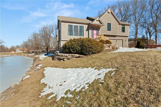 view of front of home featuring a garage and a front lawn