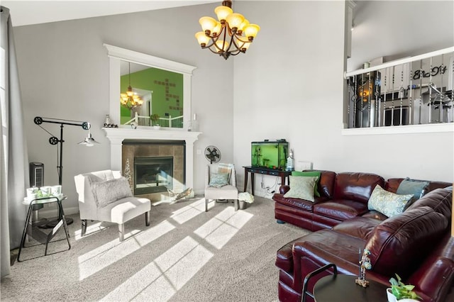 living room featuring an inviting chandelier, a tile fireplace, and carpet