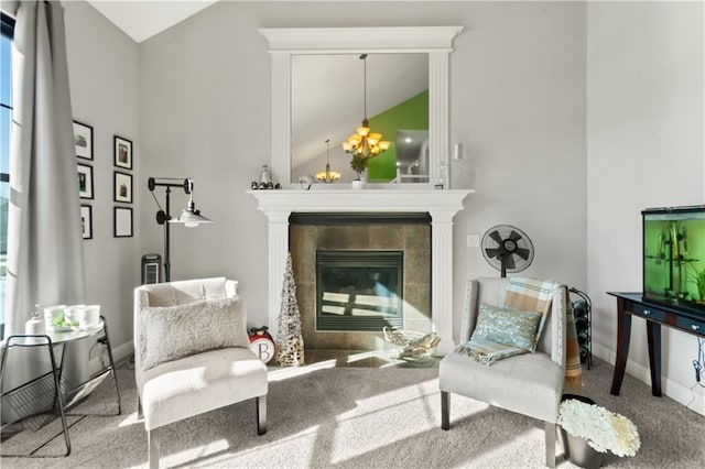 living area with lofted ceiling, carpet floors, and a tile fireplace