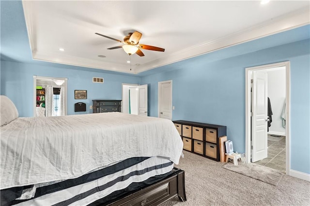 bedroom featuring ceiling fan, light colored carpet, ornamental molding, and a raised ceiling