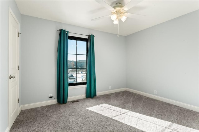 unfurnished room with ceiling fan and carpet flooring