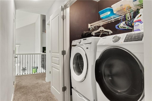 laundry room with light colored carpet and washing machine and dryer