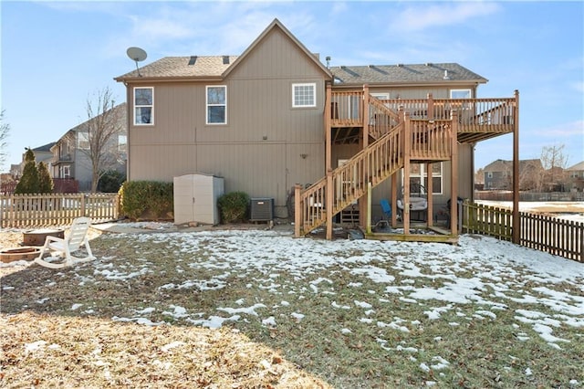 snow covered property featuring a deck and central air condition unit