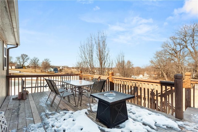 snow covered deck featuring a fire pit