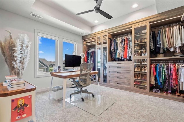 office featuring ceiling fan and a tray ceiling