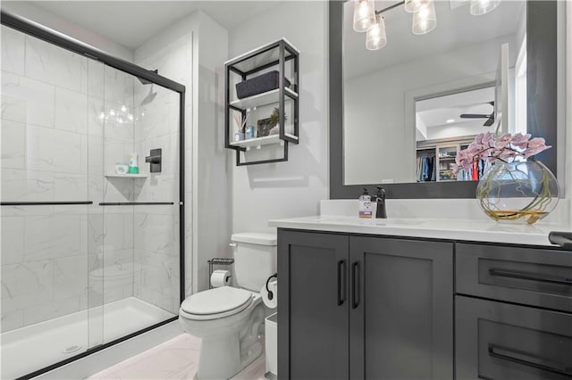 bathroom with vanity, toilet, and a shower with shower door