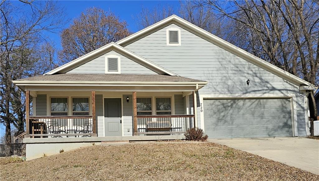 view of front of house featuring a garage and a porch