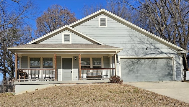 view of front of house featuring a garage and a porch