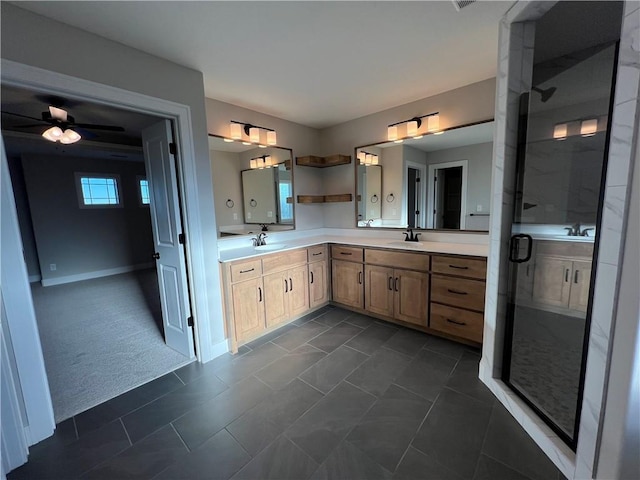 bathroom featuring a healthy amount of sunlight, a shower with shower door, tile patterned flooring, and vanity