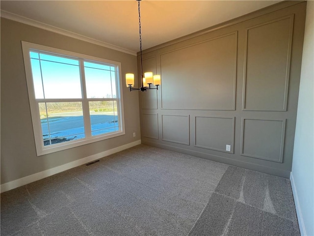 unfurnished dining area featuring an inviting chandelier, crown molding, and carpet