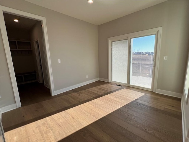 spare room featuring dark hardwood / wood-style floors