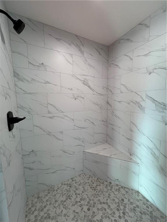 bathroom with a tile shower