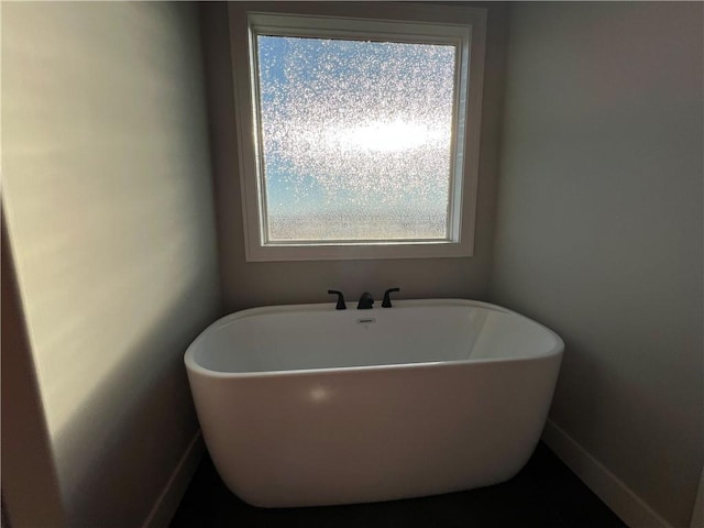 bathroom with a tub to relax in