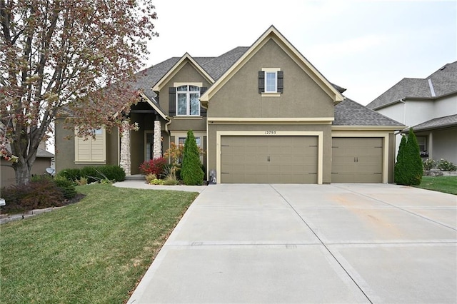 craftsman house featuring a garage and a front yard