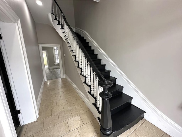 stairs with tile patterned flooring