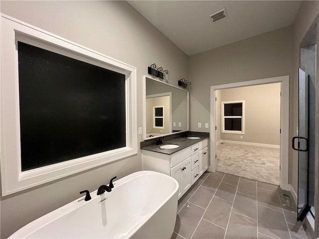 bathroom featuring vanity, tile patterned flooring, and shower with separate bathtub