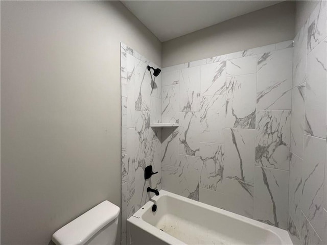 bathroom featuring toilet and tiled shower / bath combo