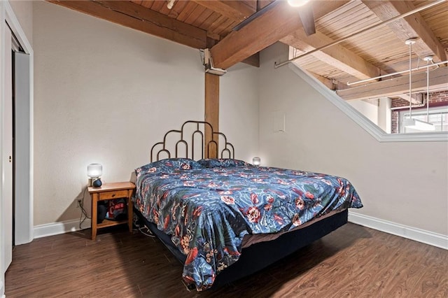 bedroom featuring beamed ceiling, wood finished floors, baseboards, and wooden ceiling