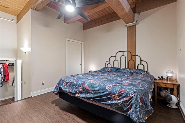 bedroom featuring beamed ceiling, baseboards, wood finished floors, and wooden ceiling