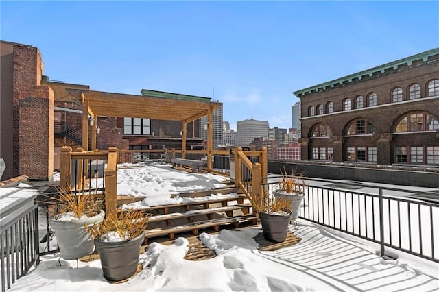 snow covered deck featuring a city view