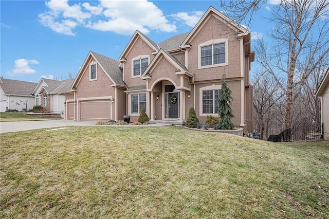 traditional home featuring a garage, a front yard, driveway, and stucco siding