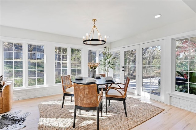 sunroom / solarium with french doors and a chandelier