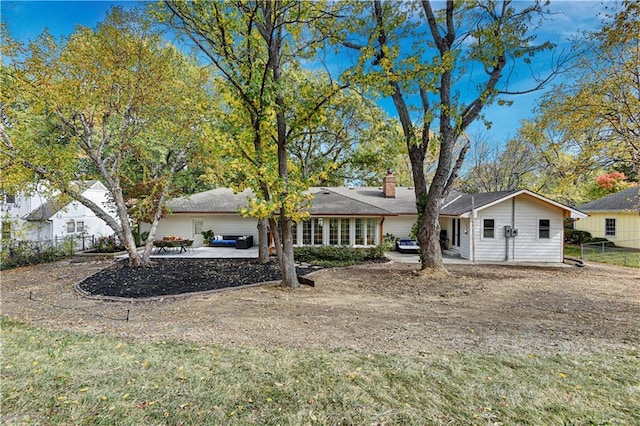 rear view of house with a yard and a patio area