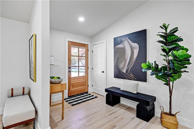 entrance foyer featuring recessed lighting, lofted ceiling, and wood finished floors