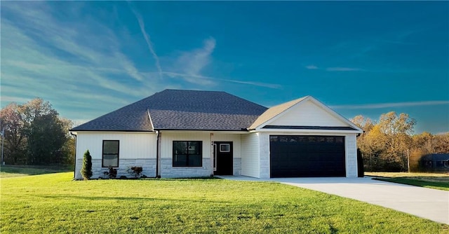 view of front of property with a garage and a front lawn