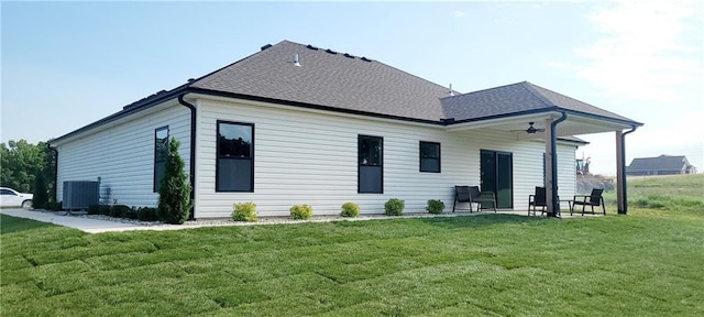 rear view of property with a lawn, ceiling fan, cooling unit, and a patio