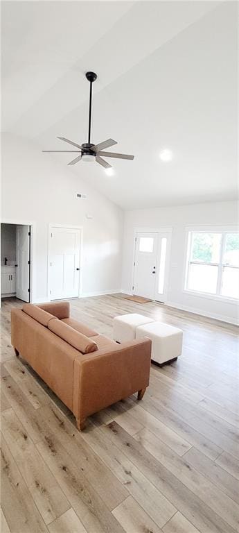 living room with high vaulted ceiling, light hardwood / wood-style flooring, and ceiling fan