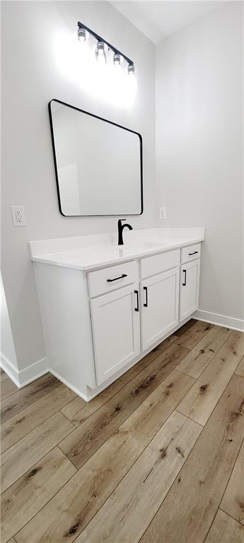 bathroom featuring vanity and wood-type flooring