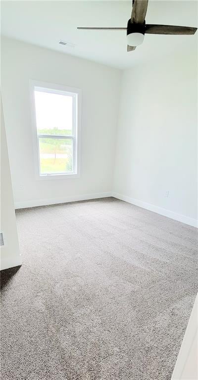 carpeted empty room featuring ceiling fan