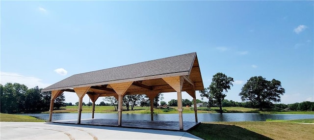 surrounding community featuring a gazebo, a water view, and a lawn