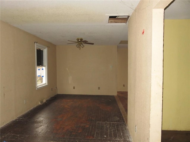 empty room with dark hardwood / wood-style floors and ceiling fan