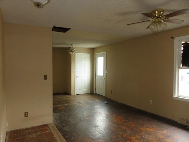 empty room with dark hardwood / wood-style flooring and ceiling fan