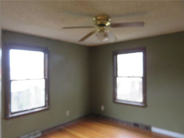 empty room featuring light hardwood / wood-style floors and ceiling fan