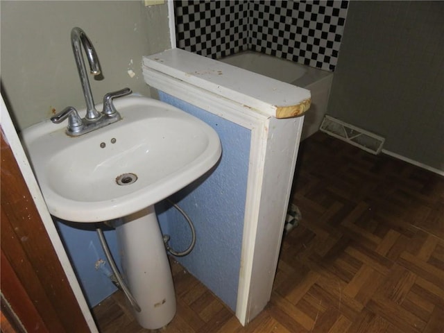 bathroom with parquet flooring