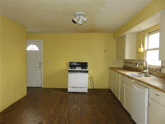 kitchen with pendant lighting, white appliances, white cabinets, sink, and a textured ceiling