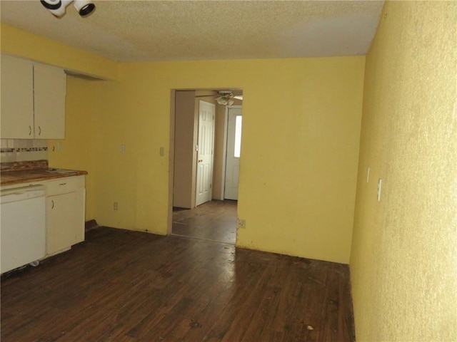 kitchen with white cabinets, a textured ceiling, ceiling fan, dark wood-type flooring, and dishwasher