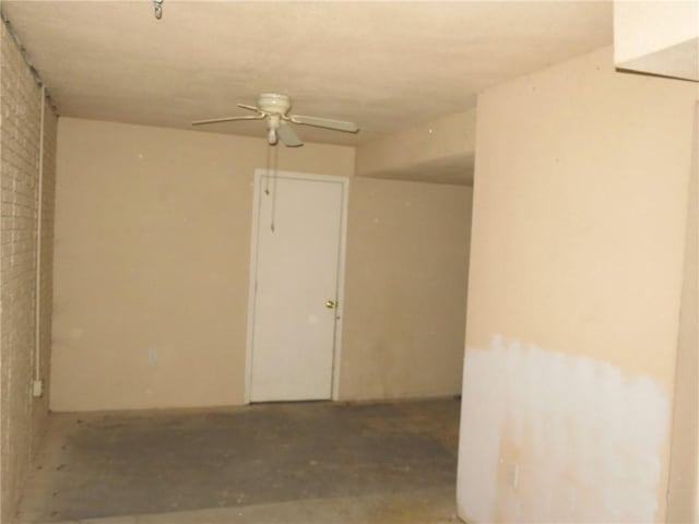 interior space with ceiling fan and concrete floors