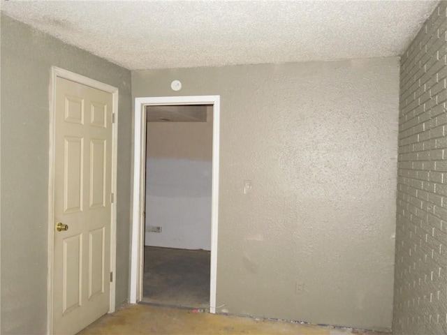 unfurnished room with a textured ceiling